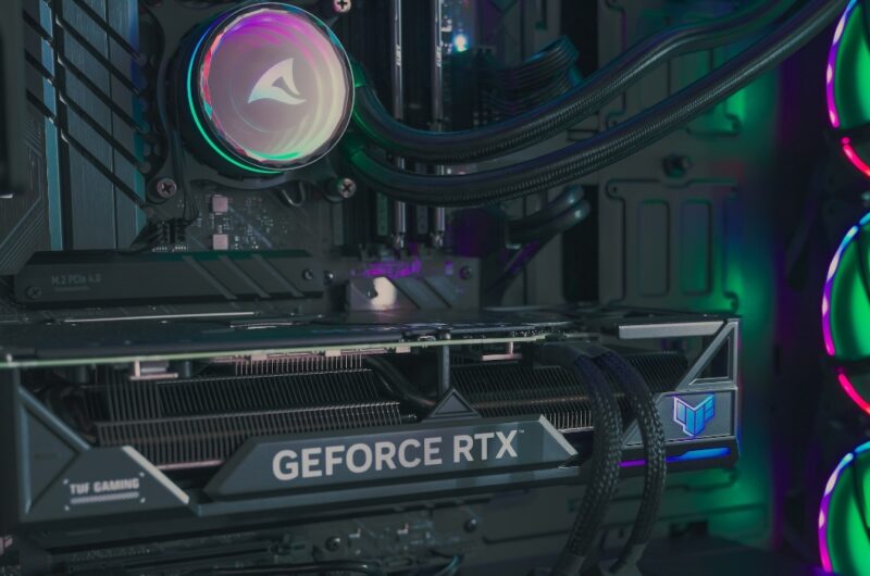 An image from inside a high-end desktop rig, showing a CPU cooler pump and a GeForce RTX graphics card.