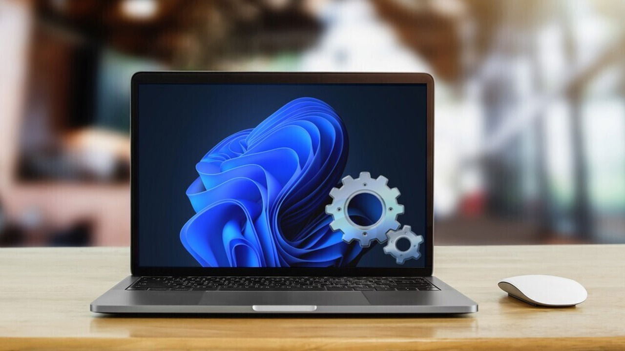 laptop on a table with Windows 11 and Windows services icon