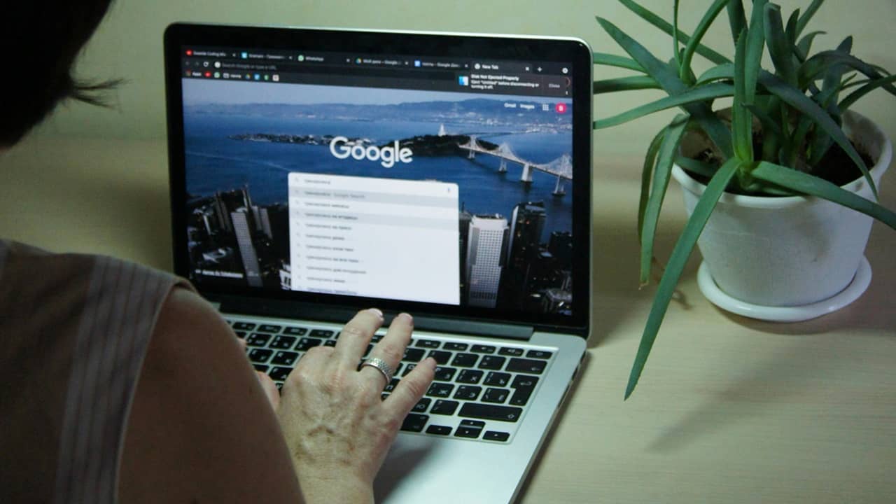 Person searching Google on their laptop.