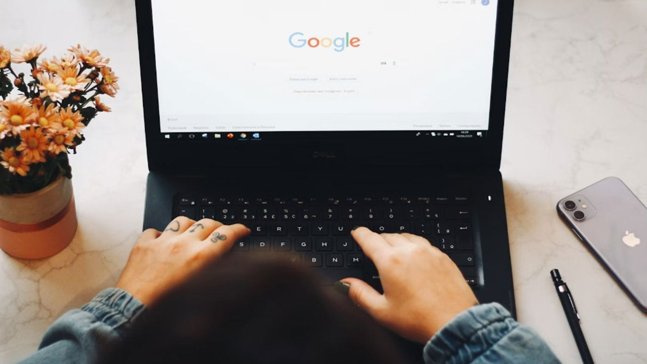 A person using Google on a laptop.